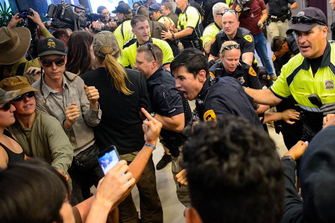 (Trent Nelson  |  The Salt Lake Tribune)  Police remove protesters occupying the Chamber of Commerce Building Salt Lake City on Tuesday, July 9, 2019. Dozens of people showed up to protest the proposed Inland Port and ended up clashing with police, resulting in temporary street closures and arrests.