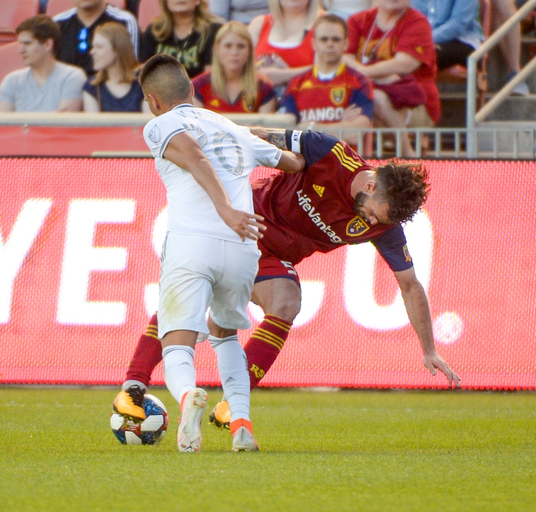 (Leah Hogsten  |  The Salt Lake Tribune) Real Salt Lake midfielder Kyle Beckerman (5) is knocked to the ground battling Los Angeles FC midfielder Eduard Atuesta (20)as Real Salt Lake hosts Los Angeles Football Club in the fourth round of the Lamar Hunt U.S. Open Cup, June 11, 2019 at Rio Tinto Stadium in Sandy.
