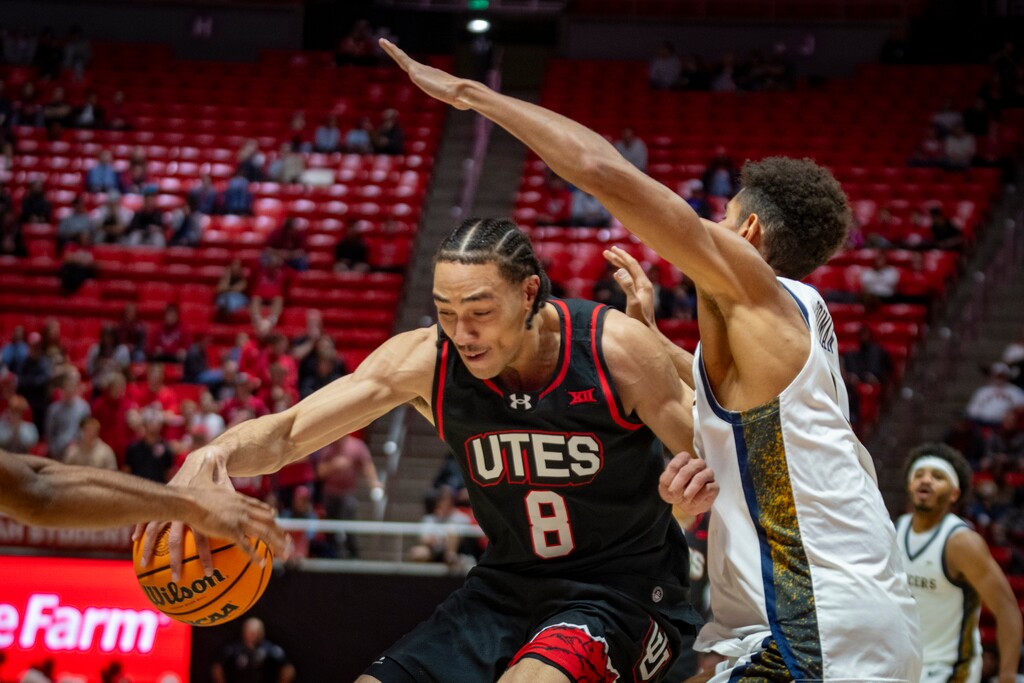 (Rick Egan | The Salt Lake Tribune) Utah Utes forward Keanu Dawes (8) takes the ball inside as California Baptist Lancers forward Jonathan Griman (8) defends him in a game last month.