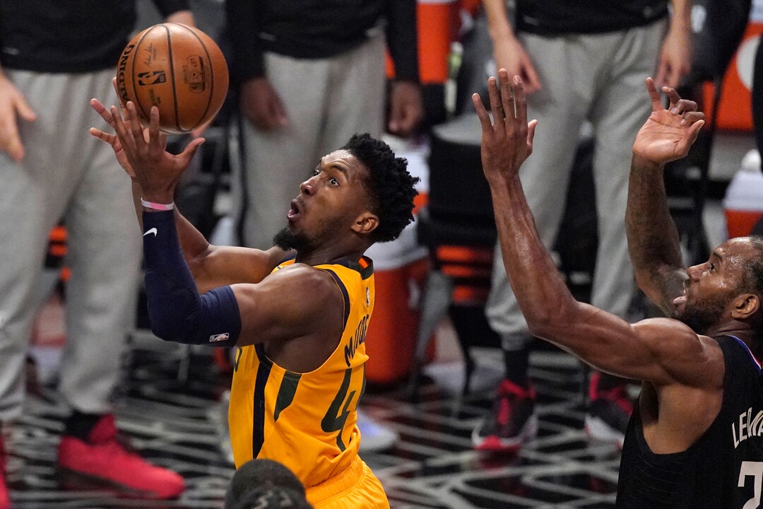 Utah Jazz guard Donovan Mitchell, left, shoots as Los Angeles Clippers forward Kawhi Leonard defends during the first half in Game 4 of a second-round NBA basketball playoff series Monday, June 14, 2021, in Los Angeles. (AP Photo/Mark J. Terrill)
