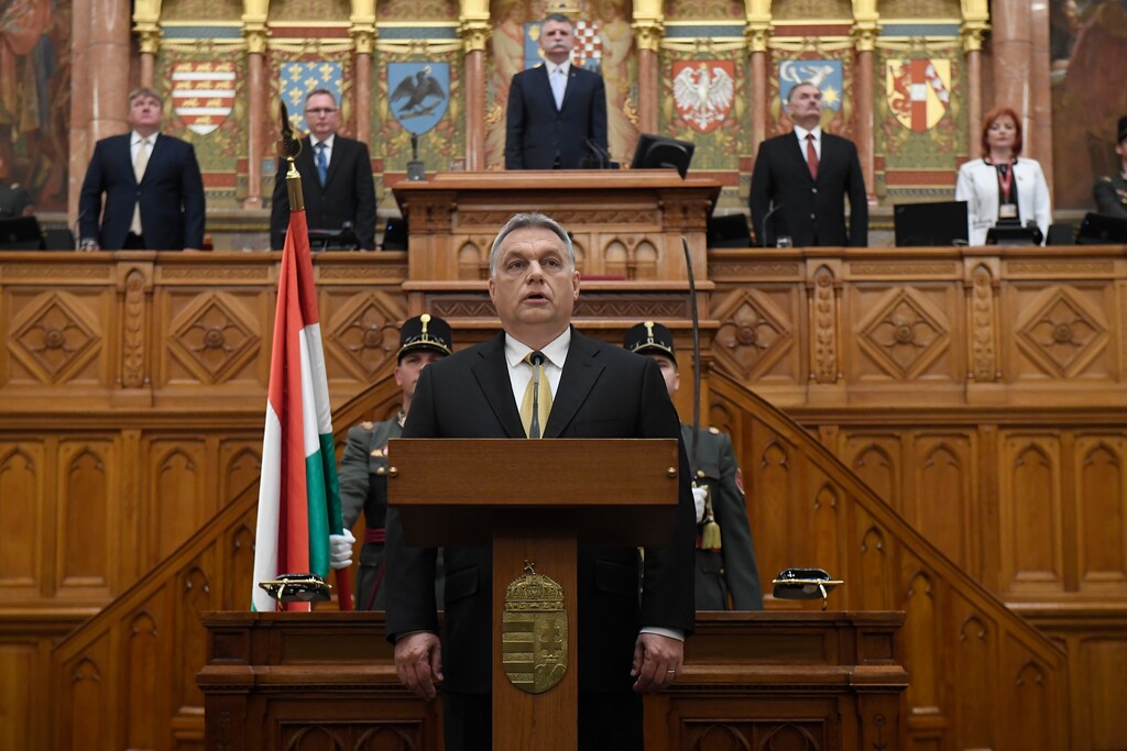 Chairman of Fidesz Party Viktor Orban takes his oath as Prime Minister of Hungary after he was re-elected for his third consecutive term in the new Hungarian Parliament in Budapest, Hungary, Thursday, May 10, 2018. Center in the background: Speaker of the Parliament Laszlo Kover. (Tamas Kovacs/MTI via AP)