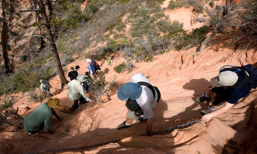 (Al Hartmann  |  The Salt Lake Tribune) Hikers carefully pick their way down the Angels Landing Trail in Zion National Park.    It's one of the premier hikes in the park which takes the hiker up and a steep rock spine that climbs to a magnificent view of the Virgin River and Zion Canyon below.  The hikes is not for those with fear of heights.  An anchor chain is embedded in the rock in steep places along the trail that hikers can grab onto for safety.