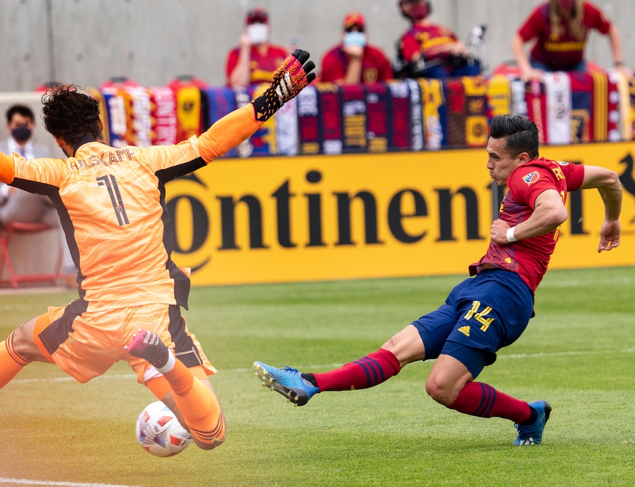 (Rick Egan | The Salt Lake Tribune)  Salt Lake forward Rubio Rubin (14) kicks the ball past Sporting Kansas City goalkeeper John Pulskamp (1) for a Real Salt Lake goal in MLS action between Real Salt Lake and Sporting Kansas City at Rio Tinto Stadium, on Saturday, May 1, 2021.