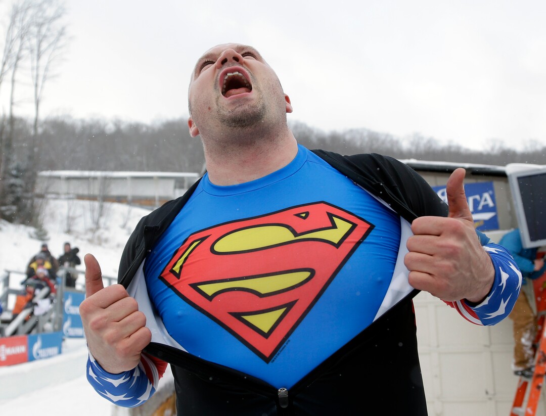 United States' Steven Holcomb celebrates after driving to a win with brakeman Steven Langton in the two-man bobsled World Cup event on Friday, Dec. 13, 2013, in Lake Placid, N.Y. (AP Photo/Mike Groll)