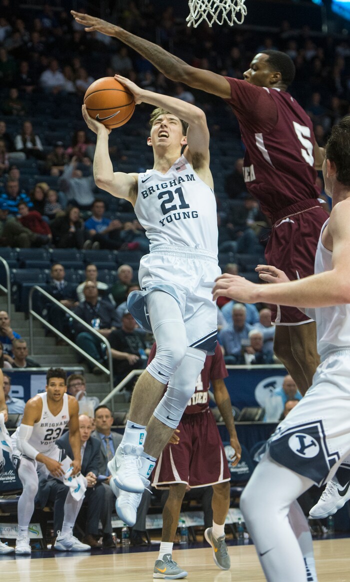 (Rick Egan  |  The Salt Lake Tribune)   Brigham Young Cougars guard Evan Troy (21) takes the ball to the basket, as Texas Southern Tigers center Trayvon Reed (5) defends, in basketball action, Brigham Young Cougars vs Texas Southern Tigers, at the Marriott Center in Provo, Saturday, December 23, 2017.
