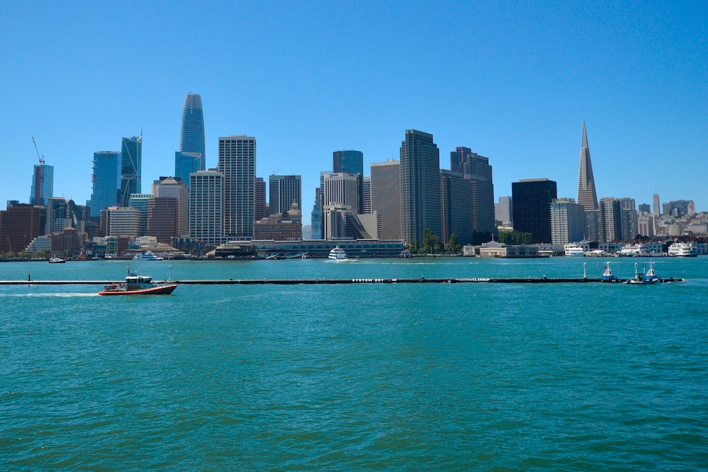 The Ocean Cleanup’s first buoyant trash-collecting device is seen in front of the San Francisco skyline en route to the Pacific Ocean on Saturday, Sept. 8, 2018. Once deployed, the boom will form a U-shaped barrier to trap plastic and trash that currently makes up the "Great Pacific Garbage Patch." (AP Photo/Lorin Eleni Gill)