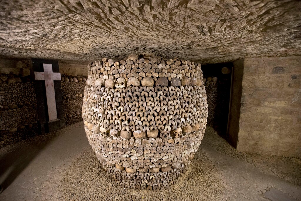 FILE - In this photo taken Tuesday, Oct. 14, 2014, skulls and bones are stacked at the Catacombs in Paris, France. French police say robbers broke into a wine collector's Paris cellar while he was away on vacation, breaking through the cellar wall via the famous "Catacombs" network of passages under the city and making off with up to 250,000 euros worth of vintage wines. (AP Photo/Francois Mori, File)