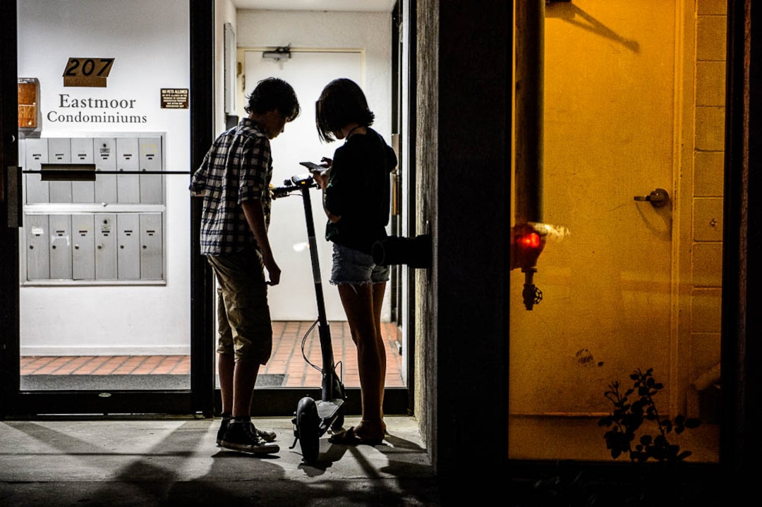 (Trent Nelson | The Salt Lake Tribune) Chase and Ady Hein capture a scooter in Salt Lake City Tuesday Aug. 7, 2018. Their mother, Jenn Hein, works as a "Bird charger" on the side to make some extra cash, picking up and charging electric scooters overnight and returning them to the city streets in the early morning.