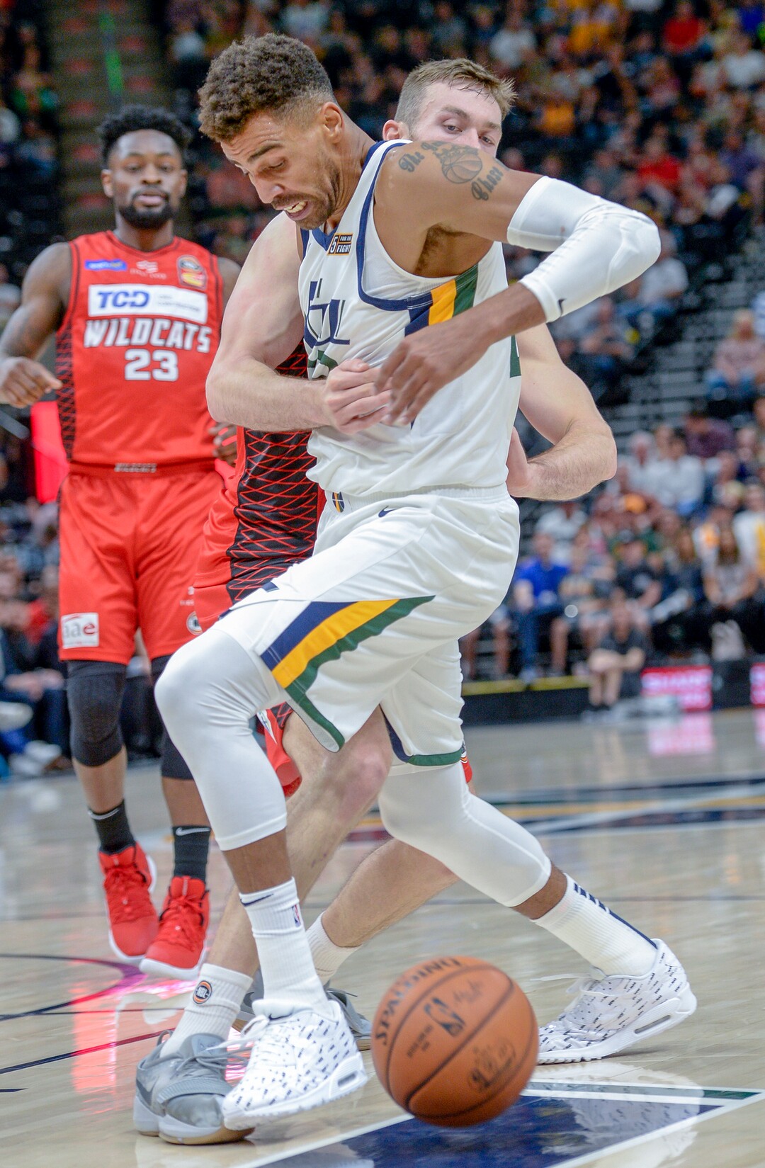 Leah Hogsten  |  The Salt Lake Tribune   Utah Jazz forward Thabo Sefolosha (22) is fouled by Perth Wildcats forward Nick Kay (3) as the Utah Jazz host the Perth Wildcats, Sept. 29, 2018 at Vivint Smart Home Arena.