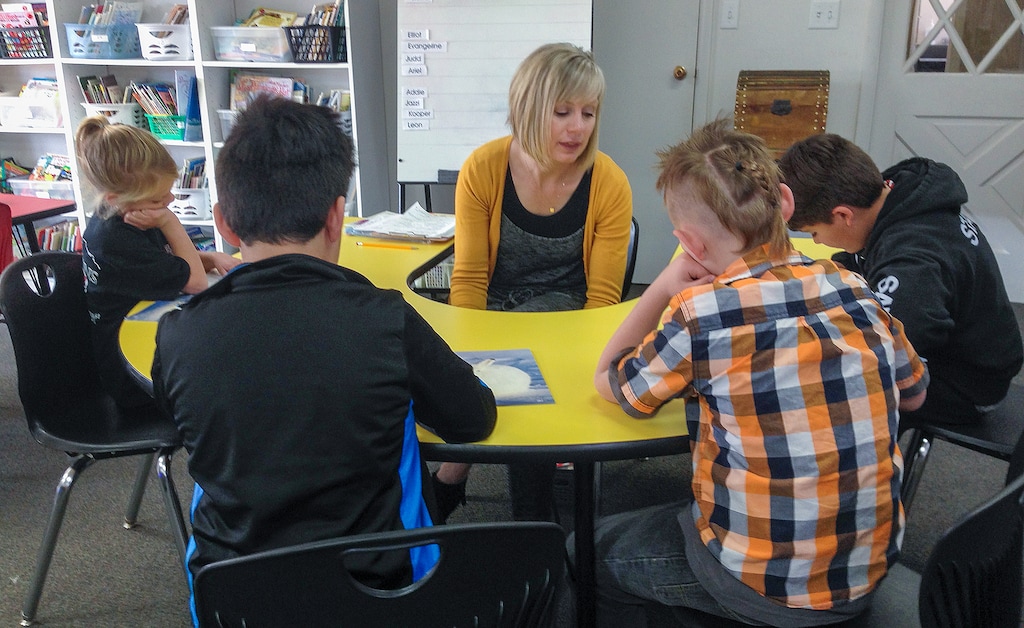 (University of Utah Reading Clinic) A University of Utah Reading Clinic tutor works with students in an undated photograph. To help the clinic expand its reach as children's literacy dropped during the pandemic, the state awarded it $1.3 million in federal education aid.