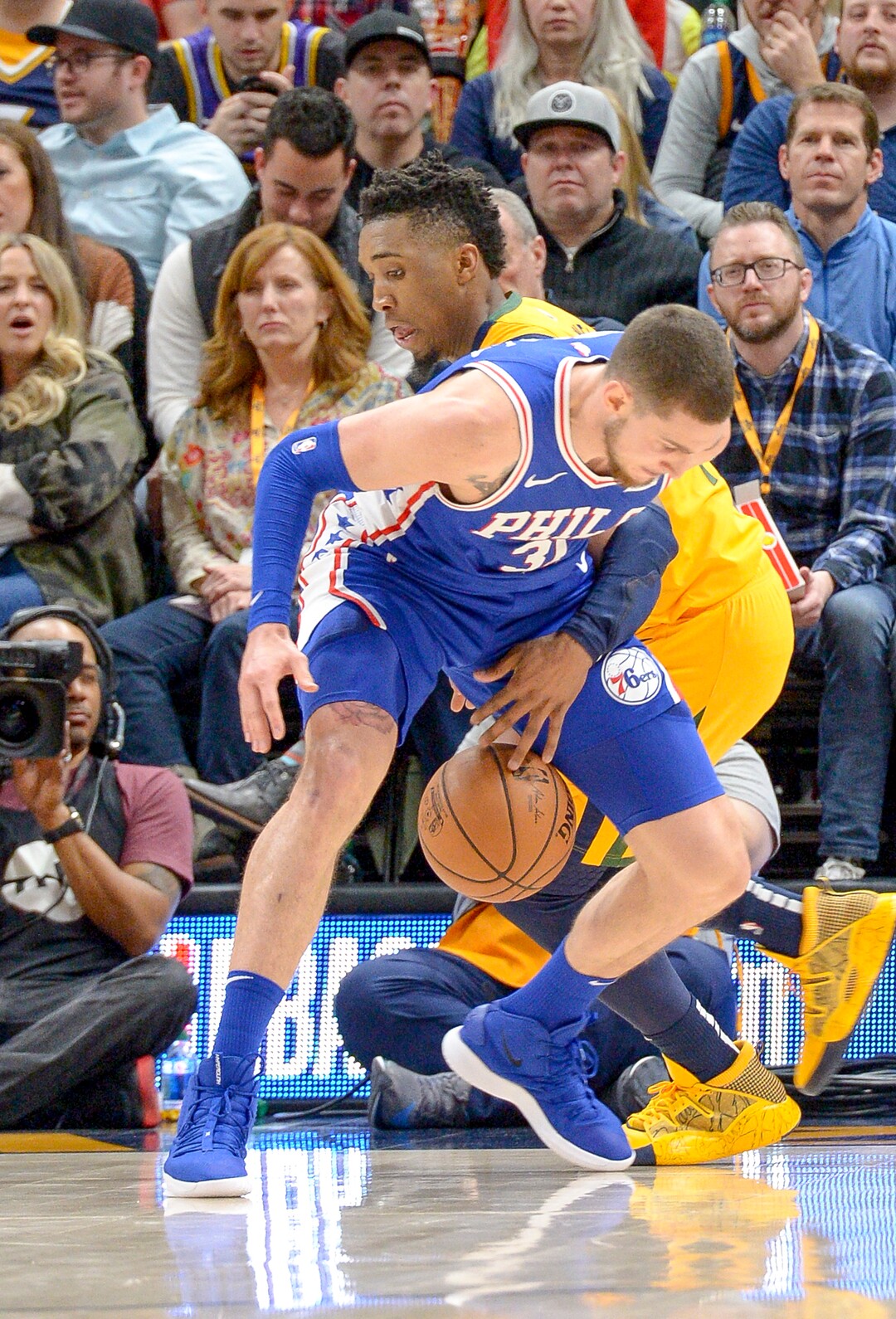 Leah Hogsten  |  The Salt Lake Tribune  Utah Jazz guard Donovan Mitchell (45) tries to steal from Philadelphia 76ers forward Mike Muscala (31). The Philadelphia 76ers defeated the Utah Jazz 114- 97 at Vivint Smart Home Arena, Thursday, December 27, 2018. 