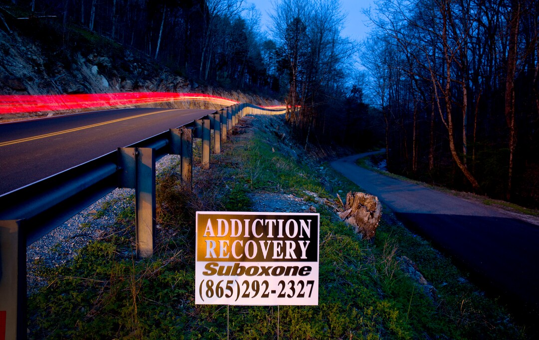 An addiction recovery sign stands beside a road in LaFollette, Tenn., Wednesday, April 11, 2018. In 2015, Campbell County had the third-highest amount of opioids prescribed per person among all U.S. counties, according to the Centers for Disease Control and Prevention. Pills, though, aren't the only problem. With 500 square miles of mountains, thick woods, winding back roads and deep hollows, this county on the Kentucky border has been a prime spot, too, for meth. While homegrown labs are on the wane, a powerful strain of the drug from Mexico has found its way here. (AP Photo/David Goldman)