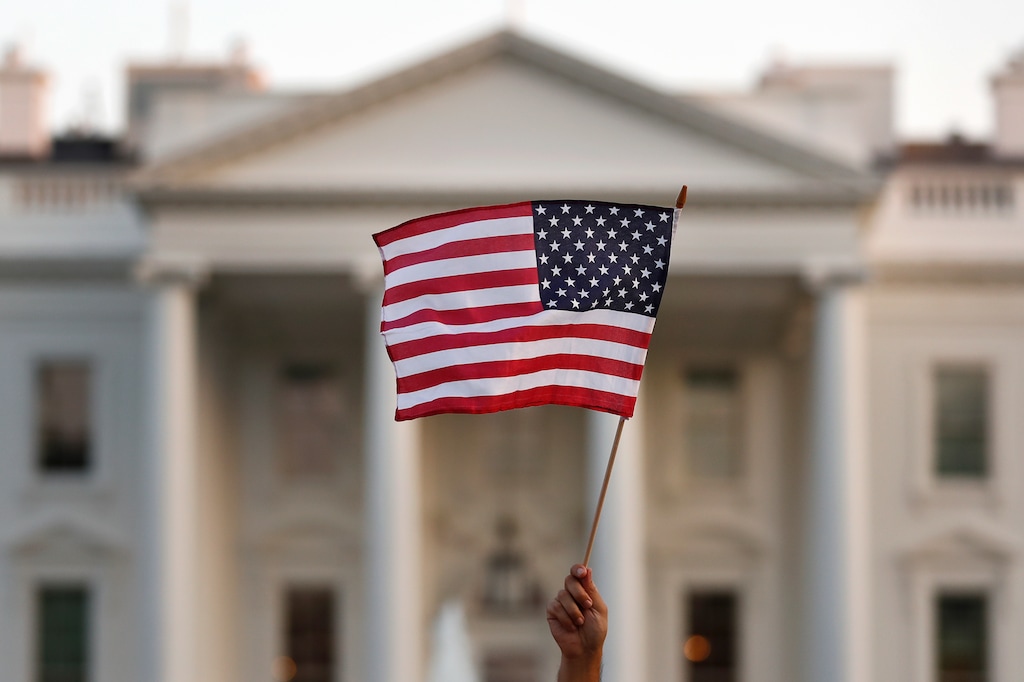 (Carolyn Kaster | The Associated Press) In this Sept. 2017 file photo, a flag is waved during an immigration rally outside the White House, in Washington.