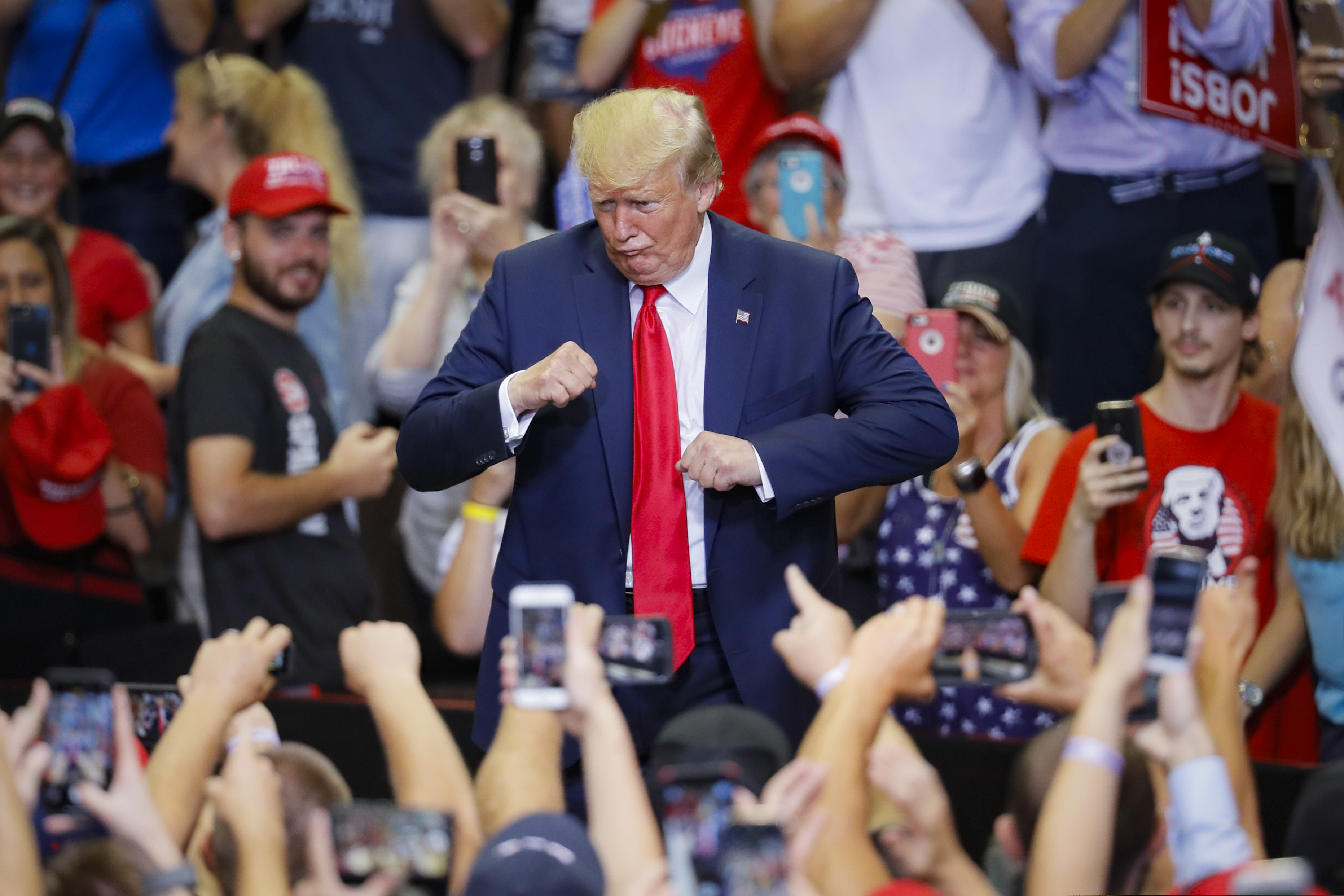 (John Minchillo | AP) President Donald Trump gestures to the crowd before exiting a campaign rally at U.S. Bank Arena, Thursday, Aug. 1, 2019, in Cincinnati.