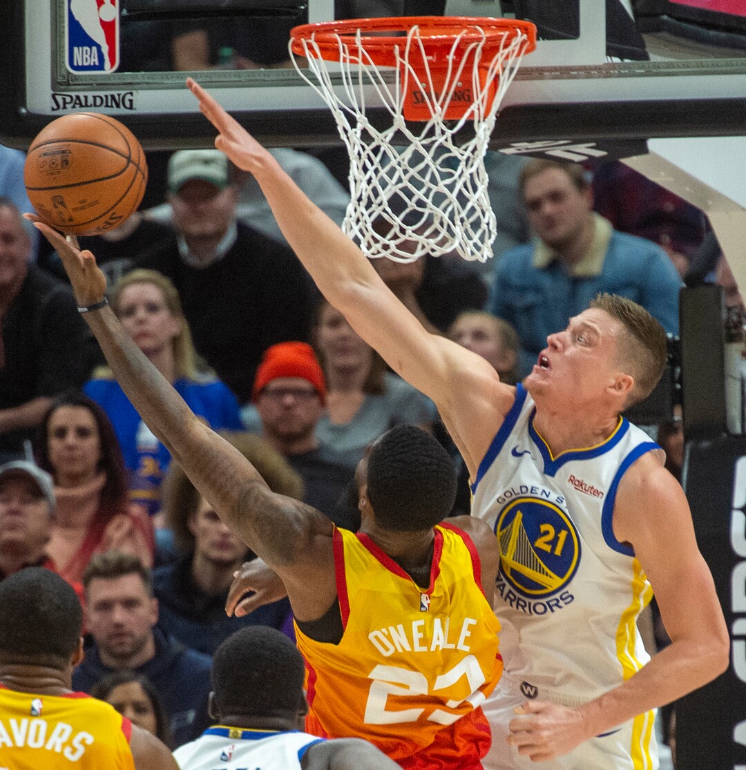 (Rick Egan  |  The Salt Lake Tribune)    Utah Jazz guard Donovan Mitchell (45) shoots as  Golden State Warriors forward Jonas Jerebko (21) defends, in NBA action between Utah Jazz and Golden State Warriors, in Salt Lake City, Wednesday, Dec. 19, 2018.