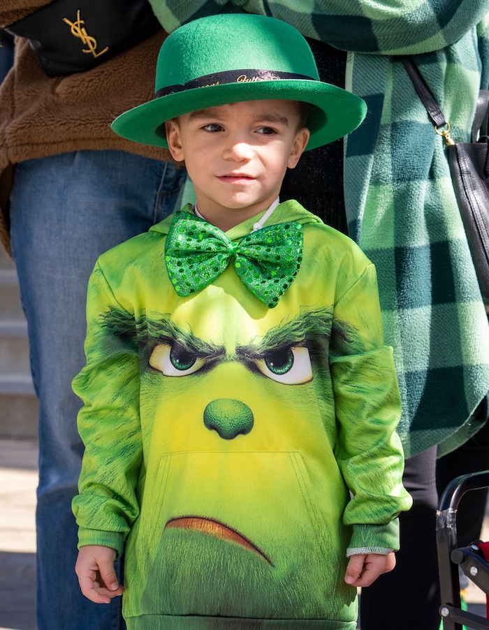 (Rick Egan | The Salt Lake Tribune) Sila Miley watches the Saint Patrick's Day Parade at the Gateway on Saturday, March 11, 2023.