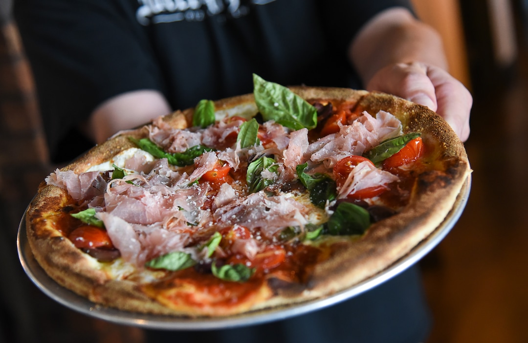 (Francisco Kjolseth  |  The Salt Lake Tribune)  A customer gets a create your own pizza at Wicked Peel Pizza Kitchen in Riverton.