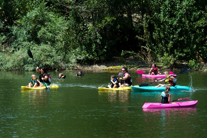 (Rick Egan  |  The Salt Lake Tribune)    Kids swim and kayak to beat the heat, as they float on Farmington Pond, Thursday, July 26, 2018.