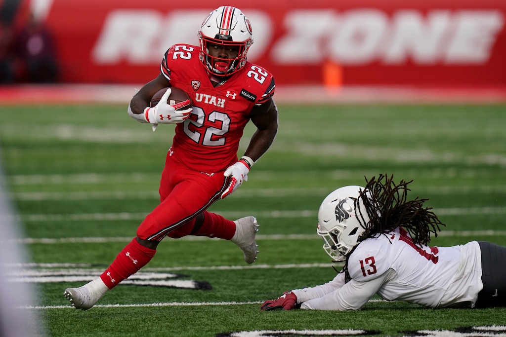 (Rick Bowmer | AP) The late Utah running back Ty Jordan (22) runs for a touchdown last season against Washington State.   Jordan will be honored with his own locker inside Rice-Eccles Stadium this season after dying from an accidental gunshot last December.