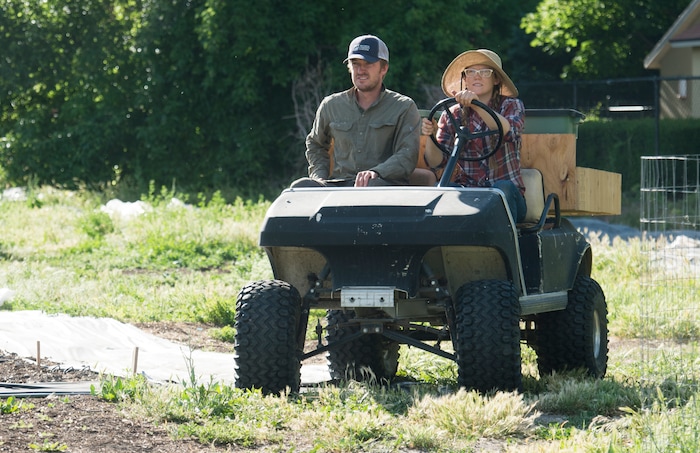 (Rick Egan  |  The Salt Lake Tribune)      Elliot Musgrove and Amanda Theobald, owners of Top Crops ride across the street to their urban farm, in Salt Lake City, Tuesday, June 5, 2018.


