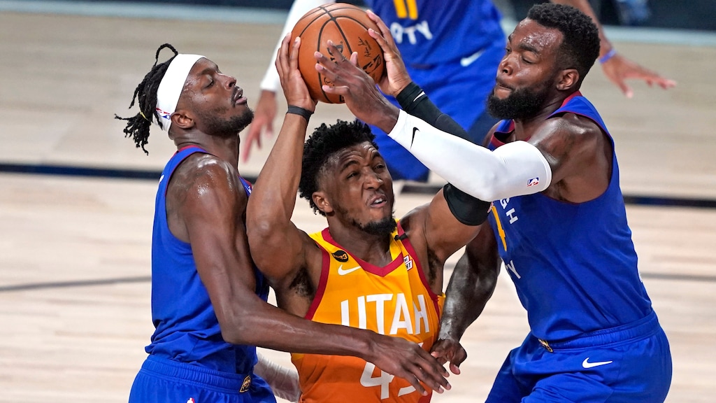 (Ashley Landis | AP) Utah Jazz's Donovan Mitchell, center, goes up for a shot as Denver Nuggets' Jerami Grant, left, and Paul Millsap, right, defend during the second half of an NBA basketball first round playoff game Sunday, Aug. 30, 2020, in Lake Buena Vista, Fla.