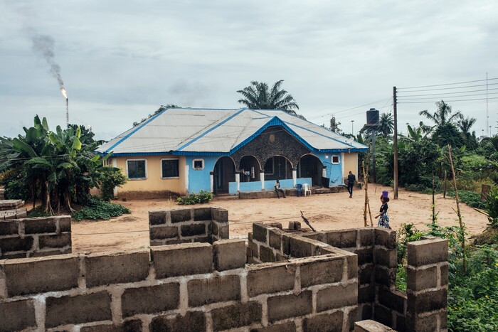 (KC Nwakalor | The New York Times) The Osi family's home and cassava farm in Obrikom, in the heart of Nigeria's oil-rich delta, July 20, 2020. Around the world, the poor and marginalized are much more likely to be vulnerable to extreme heat; methane gas flares burning around the clock in Obrikom make this already hot area worse still.