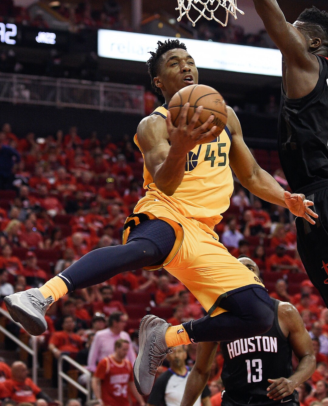 Utah Jazz guard Donovan Mitchell (45) drives to the basket as Houston Rockets center Clint Capela, right, defends during the second half in Game 1 of an NBA basketball second-round playoff series Sunday, April 29, 2018, in Houston. (AP Photo/Eric Christian Smith)