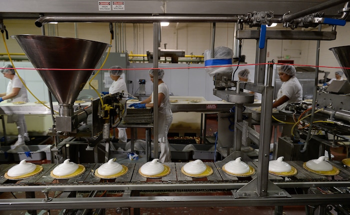 Francisco Kjolseth | The Salt Lake Tribune
Rocky Mountain Pie factor in Salt Lake assembles lemon meringue and apple pies recently. Eight different pies sold through Associated Food Stores earned blue ribbons in the commercial categories at the National Pie Championships.