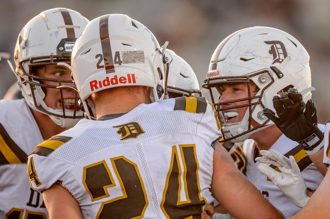 (Trent Nelson  |  The Salt Lake Tribune) Davis running back Spencer Ferguson (24) celebrates a touchdown with teammates as Herriman hosts Davis High School football, in Herriman on Thursday, Aug. 13, 2020.