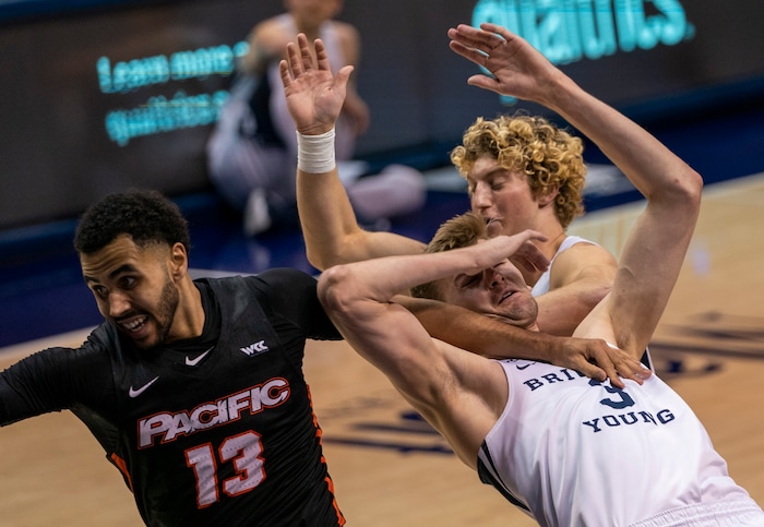 (Rick Egan | The Salt Lake Tribune)  Brigham Young Cougars forward Matt Haarms (3) gets tangled up with Pacific Tigers forward Jeremiah Bailey (13), in basketball action, between the Brigham Young Cougars and the Pacific Tigers, at the Marriott Center in Provo, on Saturday, Jan. 30, 2021.