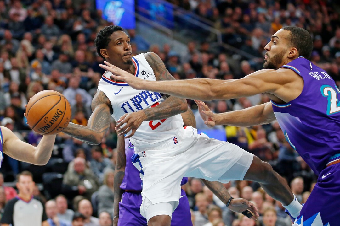 (Rick Bowmer | AP)  Los Angeles Clippers guard Lou Williams, left, passes the ball as Utah Jazz center Rudy Gobert defends during the first half of an NBA basketball game Wednesday, Oct. 30, 2019, in Salt Lake City.