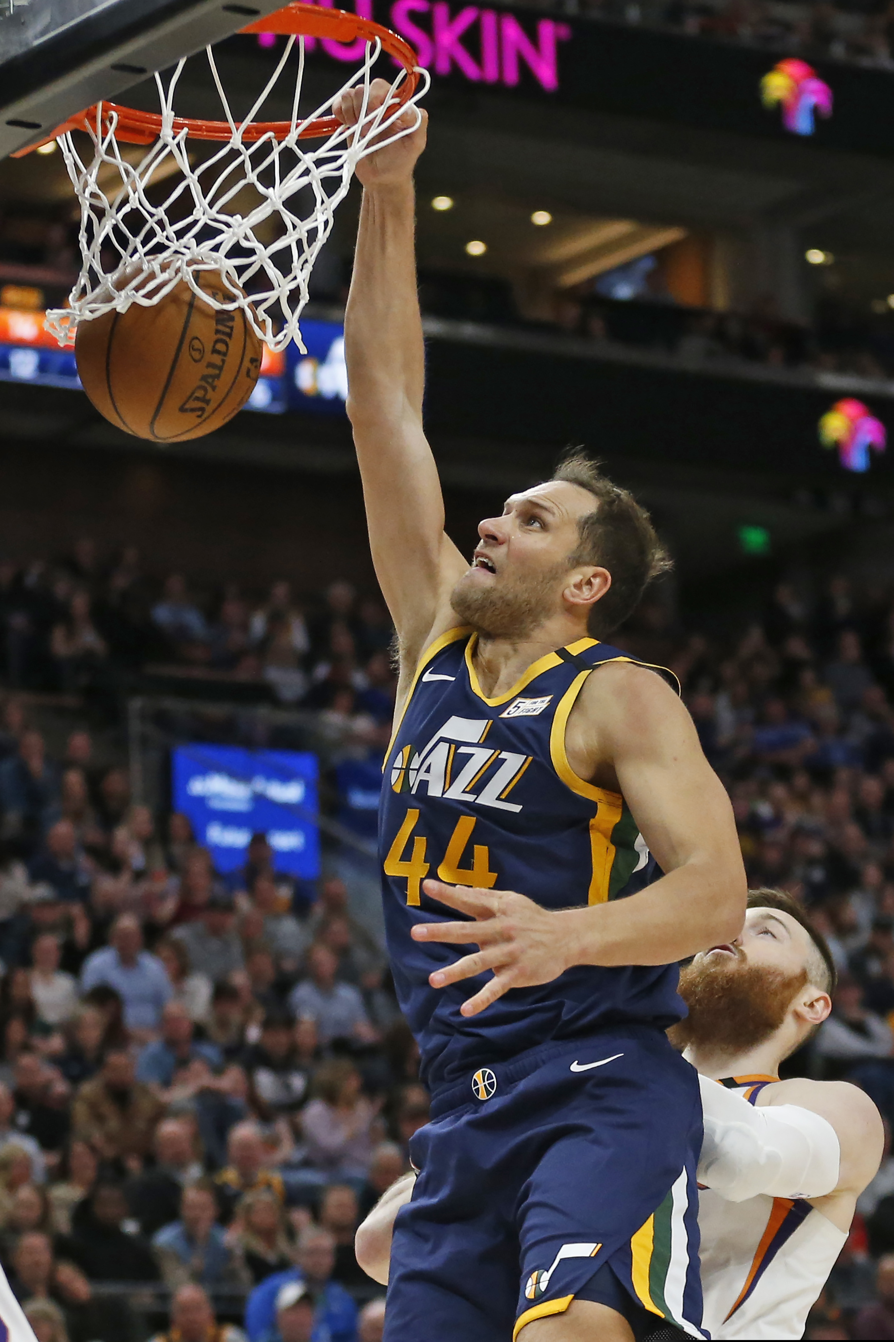 Utah Jazz forward Bojan Bogdanovic (44) dunks against Phoenix Suns center Aron Baynes, bottom right, in the first half during an NBA basketball game Monday, Feb. 24, 2020, in Salt Lake City. (AP Photo/Rick Bowmer)