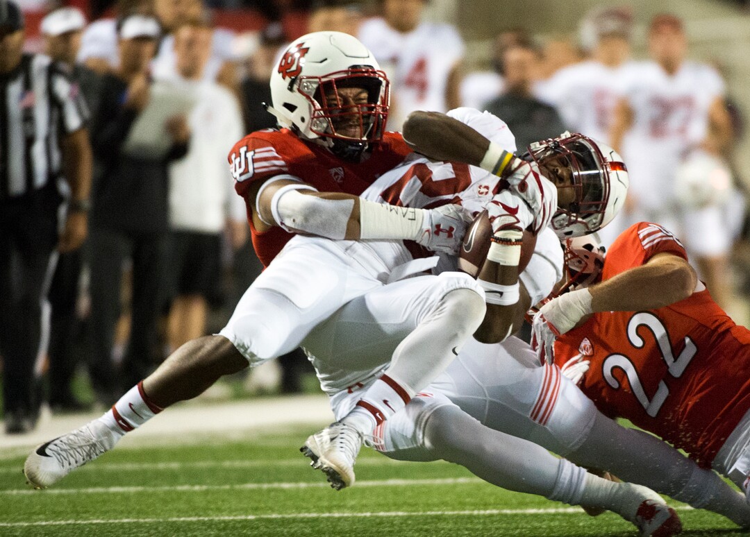 (Rick Egan  |  The Salt Lake Tribune)  Utah Utes linebacker Kavika Luafatasaga (5) and Utah Utes defensive back Chase Hansen (22), bring down Stanford Cardinal running back Bryce Love (20) in PAC-12 football action, Utah Utes vs. Stanford Cardinals, at Rice-Eccles Stadium, Saturday, October 7, 2017.