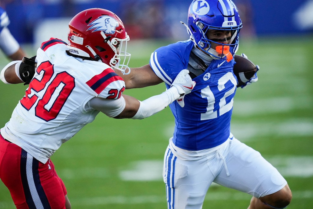 (Francisco Kjolseth | The Salt Lake Tribune) Utah Tech Trailblazers defensive back Ryan Tillman (20) pulls on BYU Cougars running back Preston Rex (12) during the first half of an NCAA college football game against Utah Tech, Saturday, Sept. 5, 2026, at LaVell Edwards Stadium in Provo.
