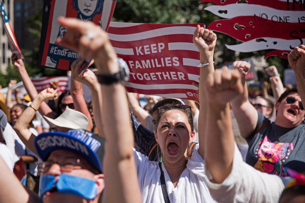 Activists shout during the rally to protest the Trump administration's immigration policies Saturday, June 30, 2018, in New York, New York. (AP Photo/Kevin Hagen)