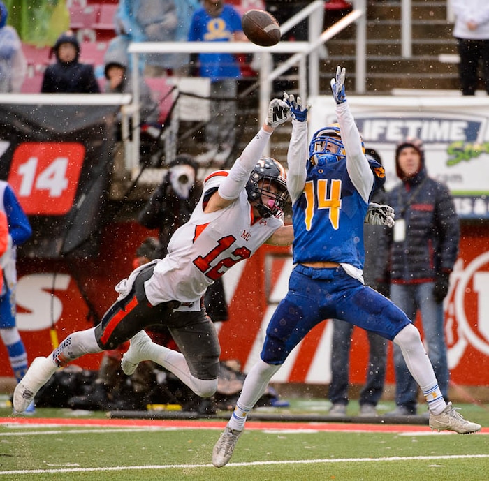 (Trent Nelson | The Salt Lake Tribune)  Orem's Trevor Rockey (14) pulls in a pass ahead of Mountain Crest's Cameron Moser (12) as Orem faces Mountain Crest in the Class 4A High School State Football Championship game in Salt Lake City, Friday November 17, 2017.