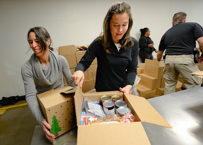 (Francisco Kjolseth  |  The Salt Lake Tribune) Director of the Salt Lake City Department of Public Utilities Laura Briefer, left, and Salt Lake City Mayor Erin Mendenhall work the line assembling food boxes as they volunteer at the Utah Food Bank for the Martin Luther King Jr. Day of Service on Monday, Jan. 20, 2020.