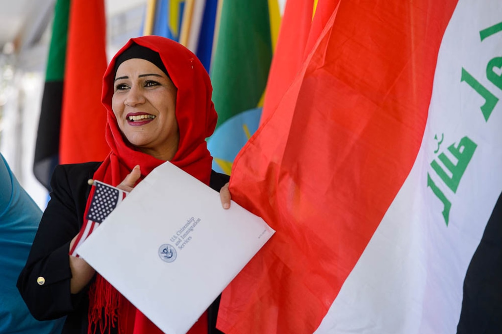 (Trent Nelson | The Salt Lake Tribune) Rasha Talib Saad Maslookhi, Iran, smiles after taking the Oath of Allegiance at World Refugee Day in Salt Lake City, Saturday June 23, 2018. The free community celebration and festival of activities, included live cultural entertainment, ethnic food, global market, and kids’ activities.