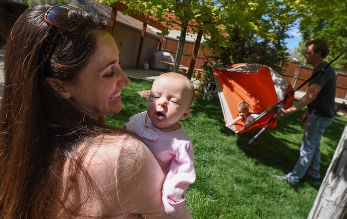 (Francisco Kjolseth | The Salt Lake Tribune) Rachel Allen coaxes a smile from her daughter Cora, 11-weeks, as she spends time in the backyard with her family. Rachel and her husband Scott are anesthesiologists in a burn unit. Scott says he wants to raise his two daughters as free range but his toddler Audrey, 3, is "constantly trying to kill herself." His wife tends to be a little more vigilant in looking after the kids. As doctors, they're trying to balance a free range childhood with safety practices to prevent their kids experiencing the injuries they witness at work every day. Utah is believed to be the first state to pass a law that prevents parents from being prosecuted for allowing mature kids with good judgement to do things alone, provided they are otherwise cared for.