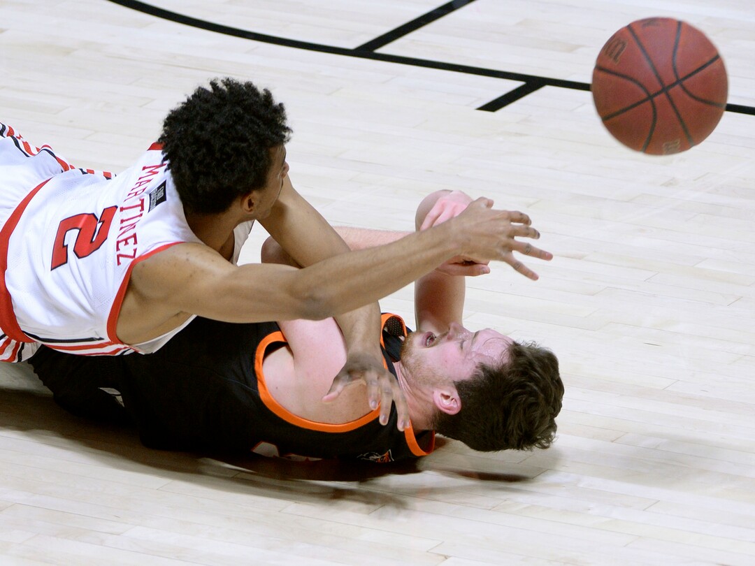 (Leah Hogsten  |  The Salt Lake Tribune) Utah Utes guard Ian Martinez (2) fires off the pass after hitting the deck with Idaho State Bengals guard Austin Smellie (5) during their NCAA basketball matchup Tuesday, Dec. 8, 2020 at the Jon M. Huntsman Center.