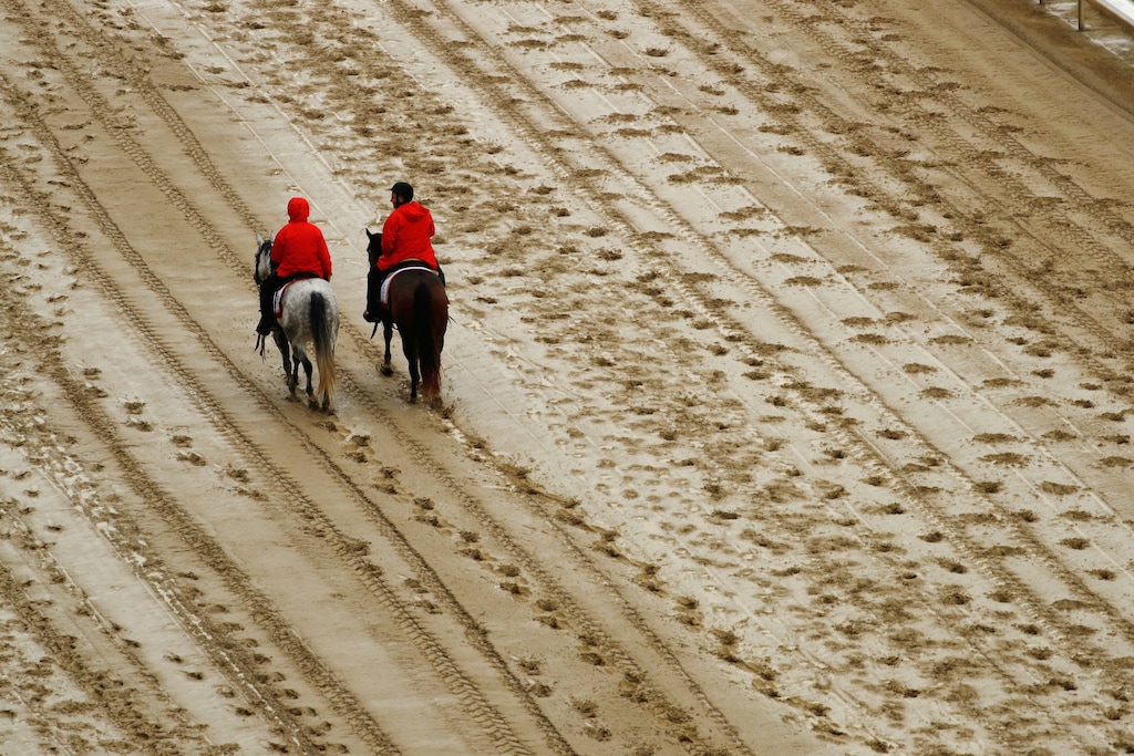 (Charlie Riedel | The Associated Press) Outriders walk on the track before the 144th running of the Kentucky Derby horse race at Churchill Downs Saturday, May 5, 2018, in Louisville, Ky.
