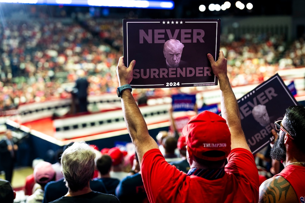 (Doug Mills | The New York Times) Attendees cheer as they listen to former President Donald Trump holds a campaign rally at the Van Andel Arena in Grand Rapids, Mich., on Saturday, July 20, 2024.
