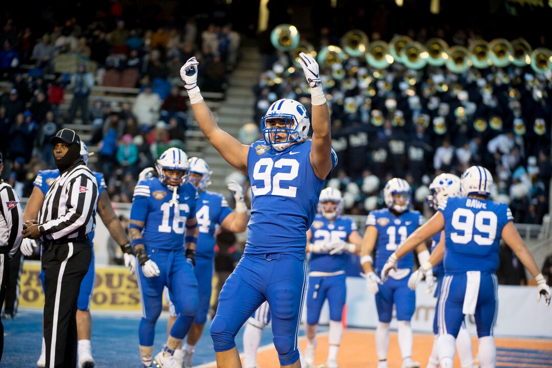 (Jeremy Harmon  |  The Salt Lake Tribune) Brigham Young Cougars defensive lineman Devin Kaufusi (92) gets the fans pumped up as BYU faces the Western Michigan Broncos in the Famous Idaho Potato Bowl in Boise, Idaho, on Friday, Dec. 21, 2018.