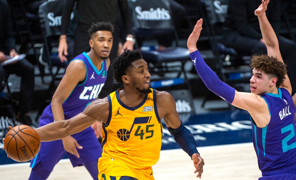 (Rick Egan | The Salt Lake Tribune) Utah Jazz guard Donovan Mitchell (45) throws a pass out to the perimeter, as Charlotte Hornets guard LaMelo Ball (2) defends, in NBA action between the Utah Jazz and the Charlotte Hornets at Vivint Arena, on Monday, Feb. 22, 2021.