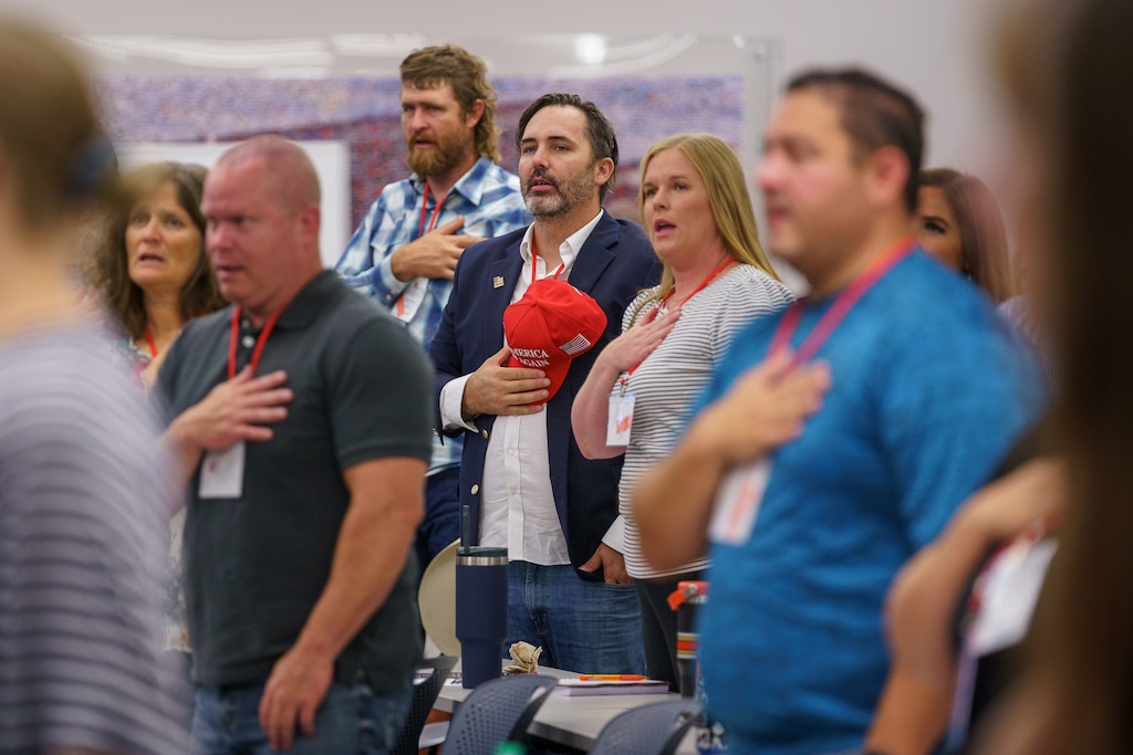 (Trent Nelson  |  The Salt Lake Tribune) The Pledge of Allegiance as the Utah Republican Party holds its quarterly State Central Committee meeting in Sandy on Saturday, Aug. 19, 2023.