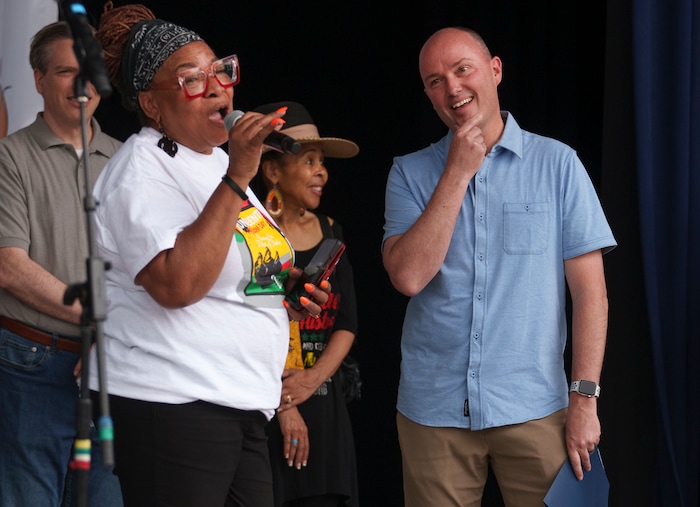 (Leah Hogsten | The Salt Lake Tribune) l-r Betty Sawyer, the Director of the African-American community group Project Success Coalition, introduces Governor Spencer Cox at the Utah Juneteenth Festival at the Ogden City Amphitheater, Saturday, June 18, 2022. Juneteenth celebrates emancipation from slavery. 