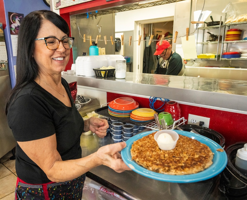 (Rick Egan | The Salt Lake Tribune)  Lisa Adamson serves a cinnamon granola pancake, at The Sunshine Cafe, in North Salt Lake, on Friday, Feb. 4, 2022.