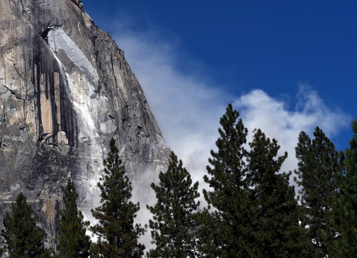 A second rock fall occurs at El Capitan Thursday, Sept. 28, 2017, in Yosemite National Park, Calif. Yosemite National Park says another rock fall has injured one person in the park, one day after a huge chunk of granite killed a British tourist, Andrew Foster, 32, of Wales, while he and his wife were hiking at the bottom of El Capitan. An immense mass of granite plunged from the side of El Capitan on Thursday and filled the valley below with a cloud of dust. (Eric Paul Zamora/The Fresno Bee via AP)