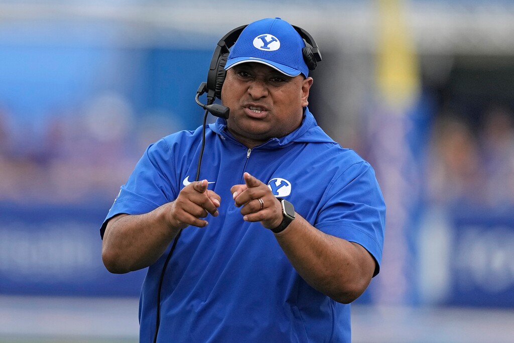 BYU head coach Kalani Sitake talks to his players during the first half of an NCAA college football game against Kansas Saturday, Sept. 23, 2023, in Lawrence, Kan. (AP Photo/Charlie Riedel)