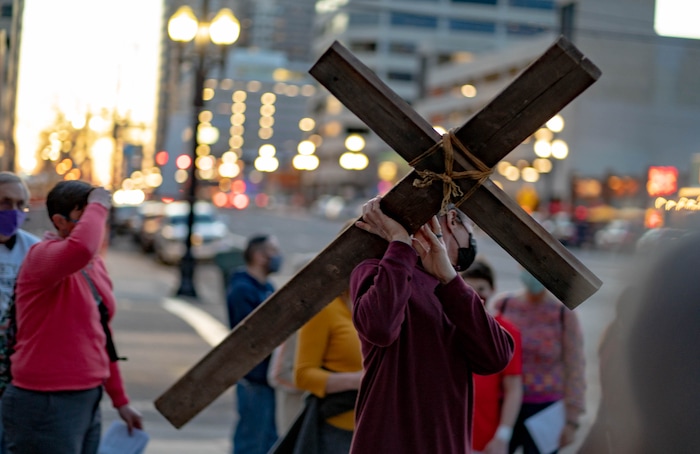 (Francisco Kjolseth | The Salt Lake Tribune) Mask wearing Utah Christians walk the streets of Salt Lake City beginning at Cathedral of the Madeleine on Good Friday, to symbolically mark Jesus' carrying the cross to his crucifixion, April 2, 2021.